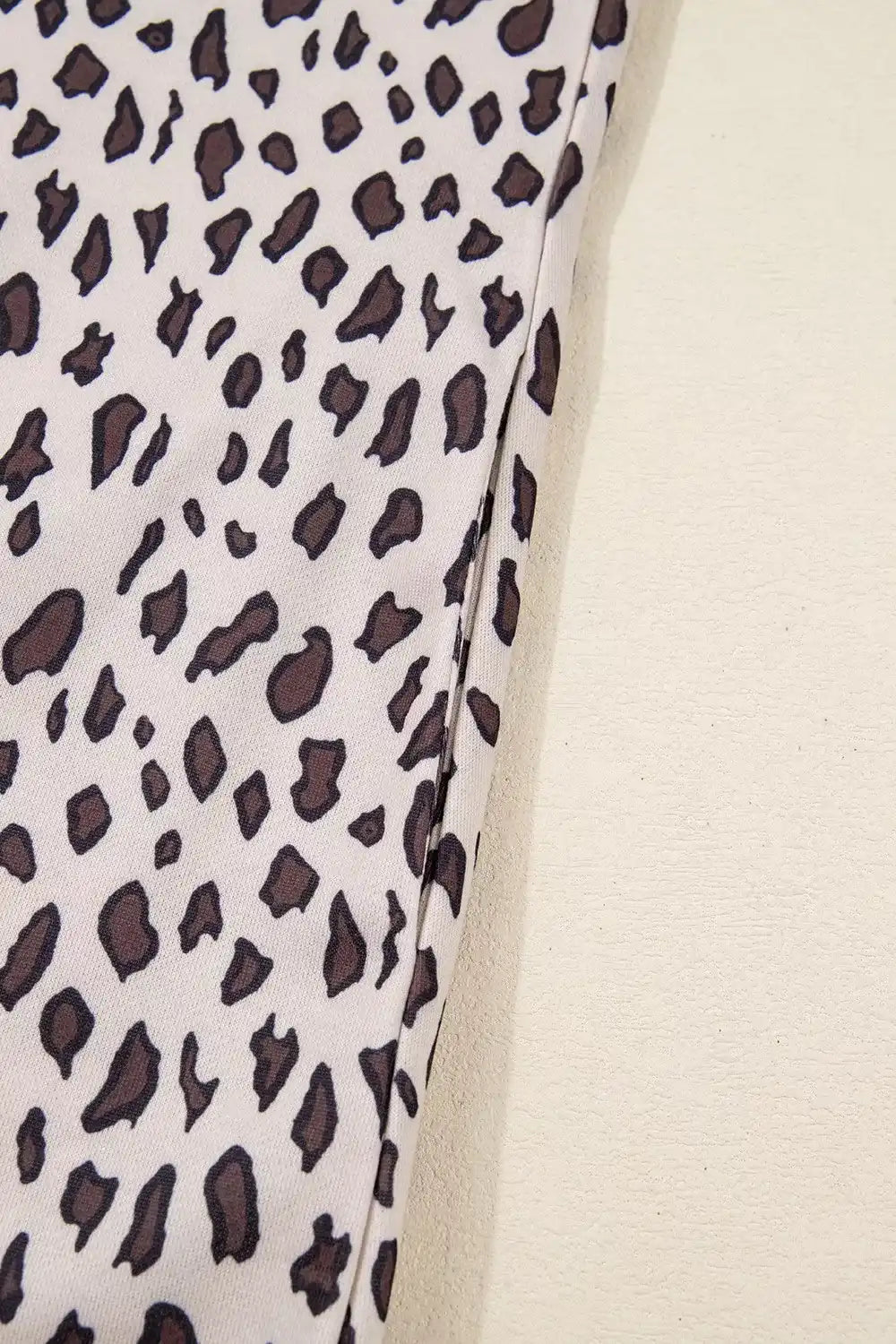 close-up of beige fabric with black and brown leopard print pattern