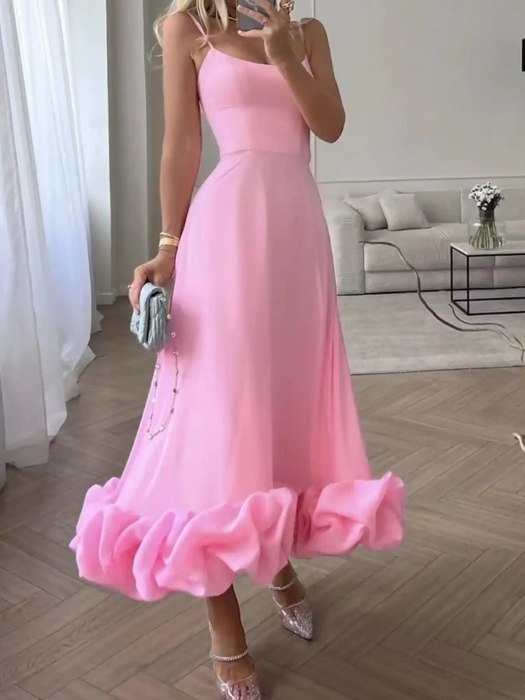 Pink ruffle hem midi dress with spaghetti straps, paired with sparkly heels and clutch for trendy women's fashion