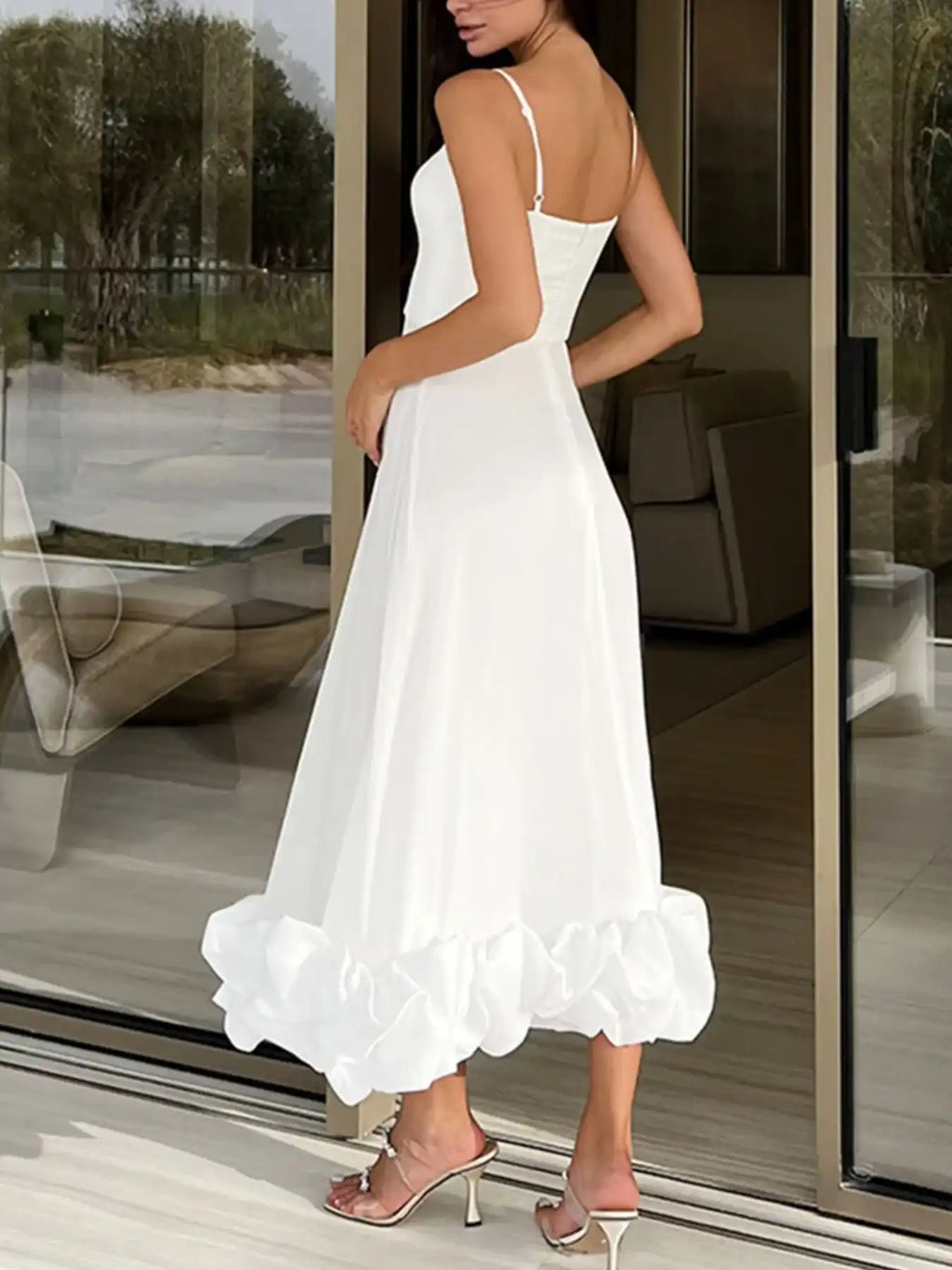 White ruffle hem midi dress with spaghetti straps, perfect for elegant occasions and everyday chic style.