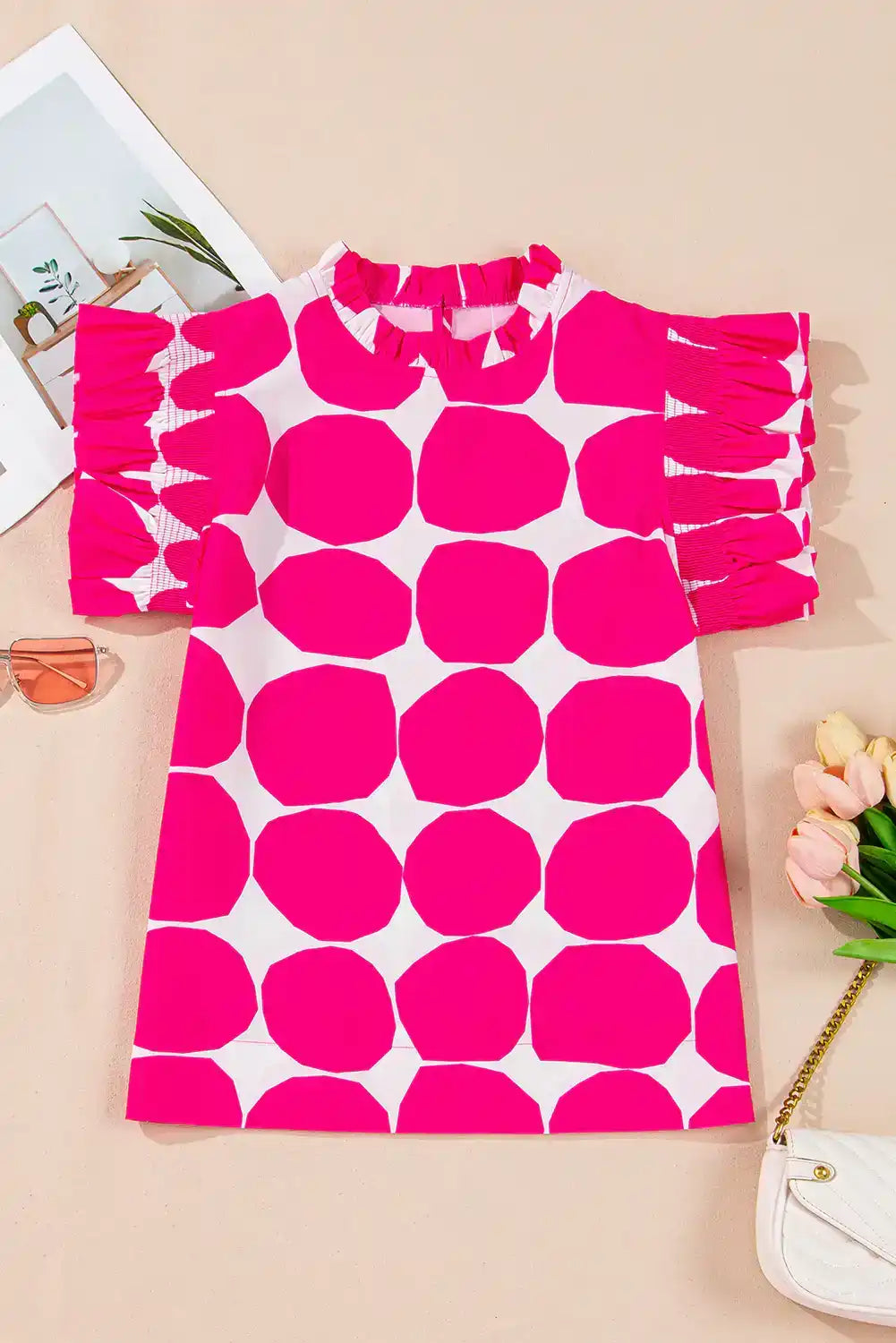 Pink and white polka dot short sleeve dress with ruffle sleeves, flat lay