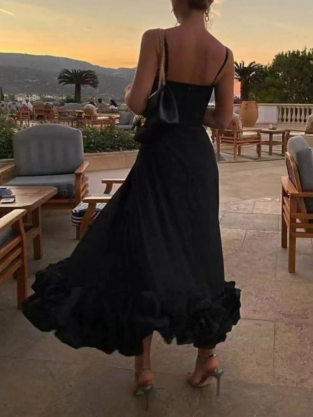 Black ruffle hem midi dress with spaghetti straps, perfect for evening wear or boutique fashion