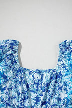 Blue floral print women’s blouse with puff sleeves on white background