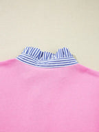 Pink top with blue and white striped ruffled collar, close-up of back neckline.