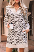Woman wearing a long sleeve leopard print mini dress with pockets, holding a coffee cup