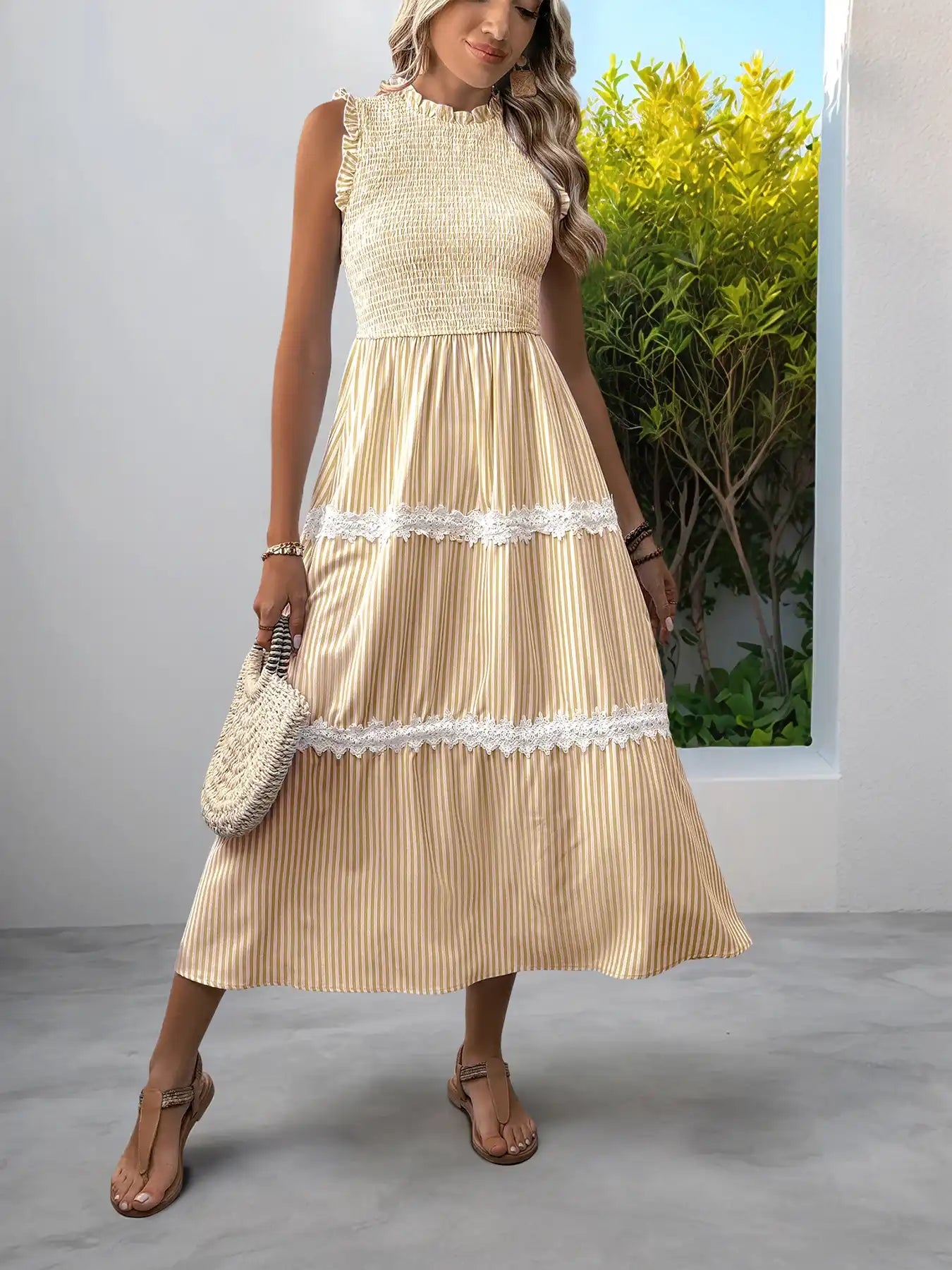 Beige striped midi dress with lace trim, paired with woven bag and sandals for summer style