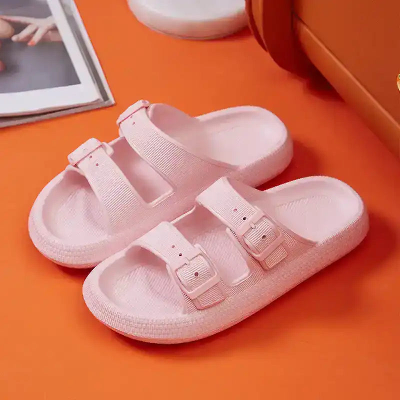 Light pink double buckle slide sandals for women on orange background