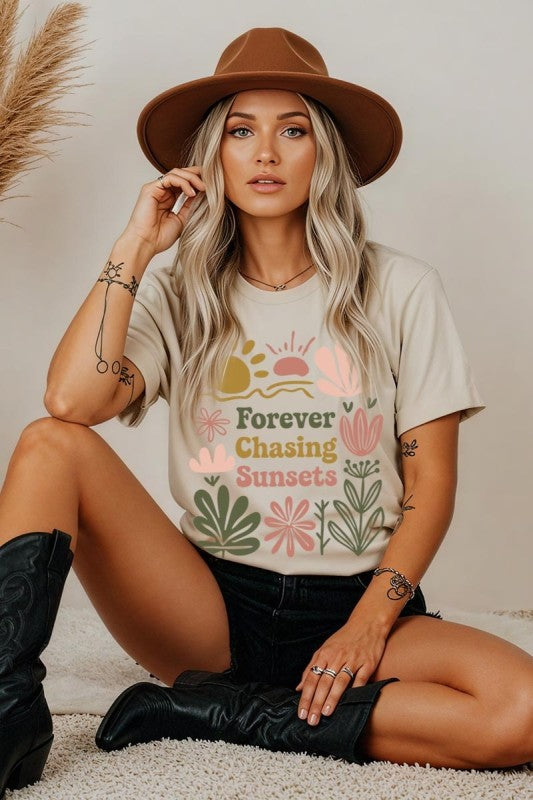 Woman wearing a t-shirt with floral design and text, sitting on the floor.
