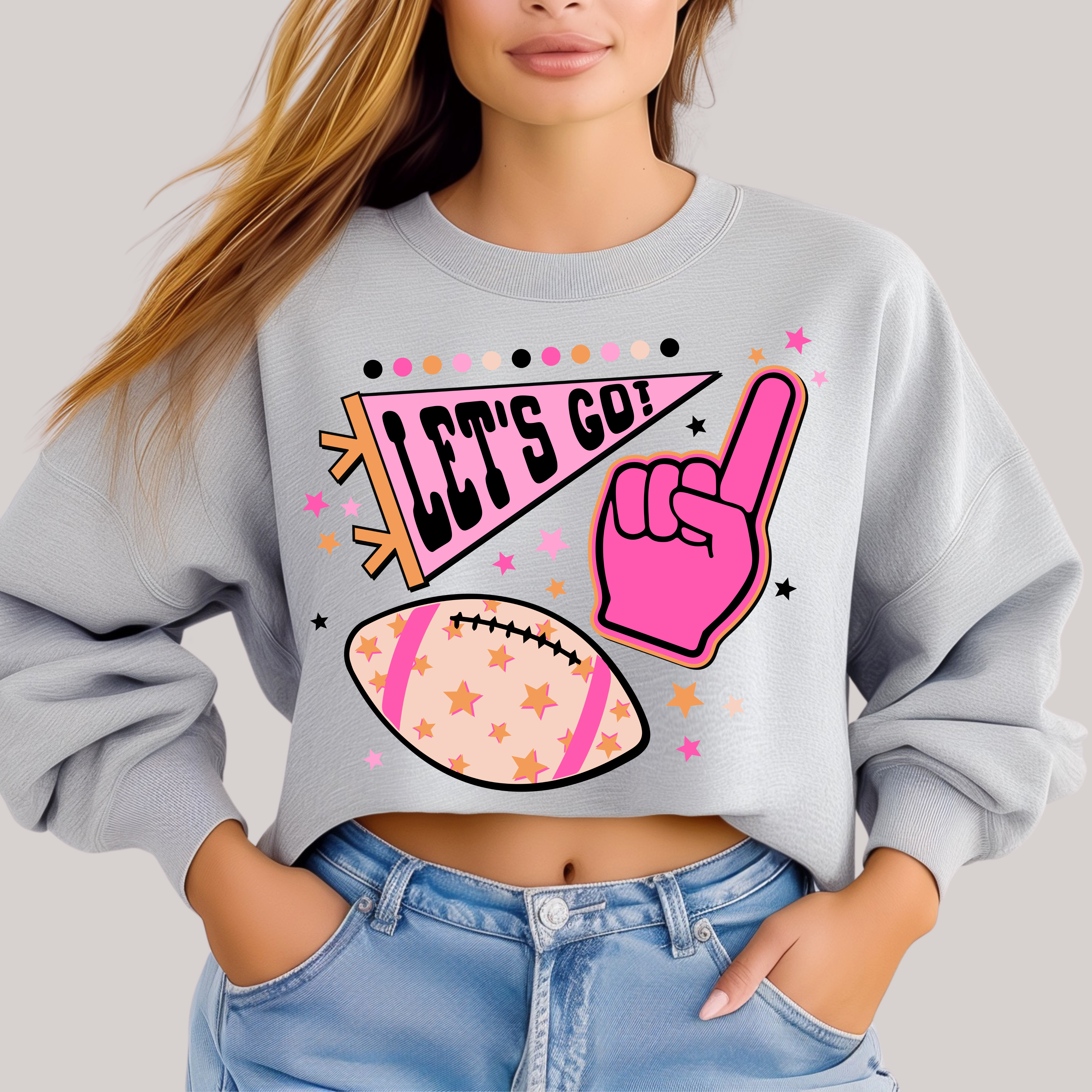 Person wearing a gray sweatshirt with sports-themed graphics and text.