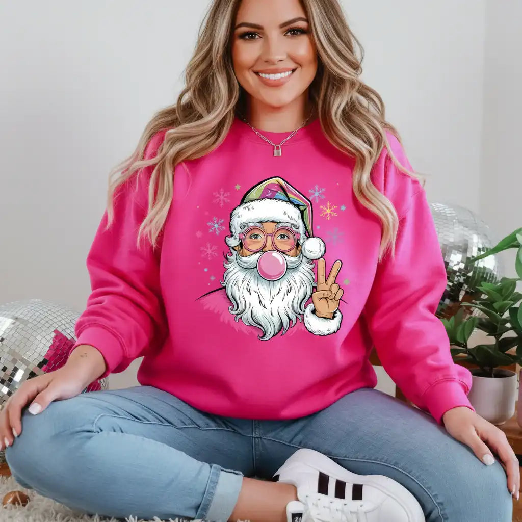 Woman wearing a pink sweatshirt with a cartoon Santa Claus design, sitting on a couch.