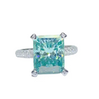 Ring with a green gemstone on a white background