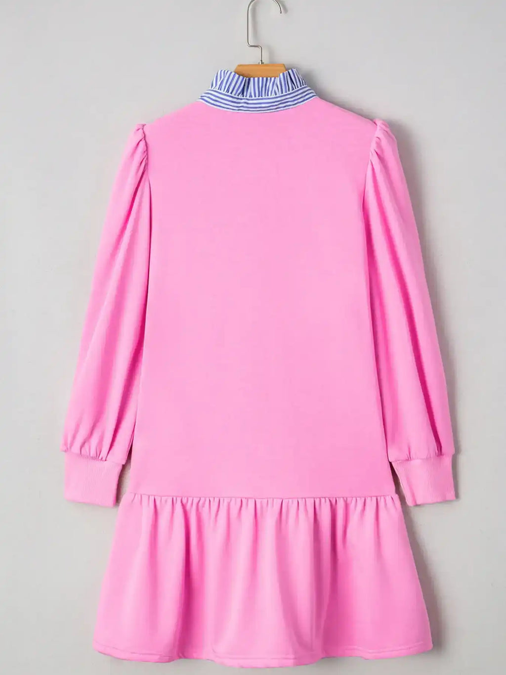 Pink long sleeve ruffle dress with blue striped collar, hanging on a hanger