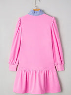 Pink long sleeve ruffle dress with blue striped collar, hanging on a hanger