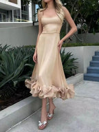 Beige ruffle hem midi dress with bow heels, perfect for trendy women's fashion