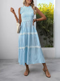 Light blue striped tiered midi dress with lace trim, sleeveless high neck, paired with sandals and woven bag