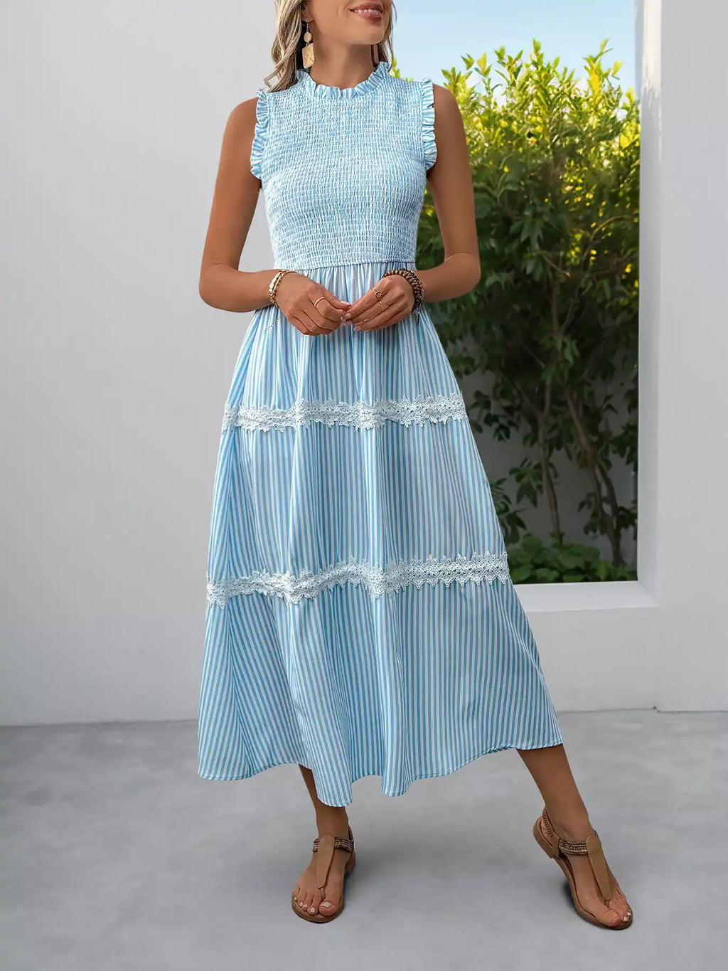 Light blue striped tiered midi dress with lace trim and ruffled neckline, perfect for summer outfits.