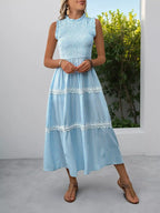 Light blue striped tiered midi dress with lace trim and ruffled neckline, perfect for summer outfits.
